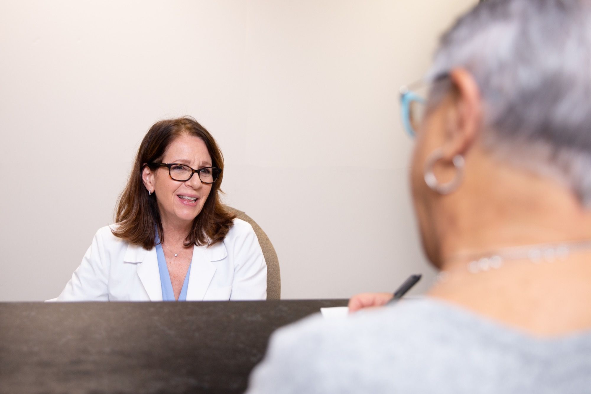 An optometrist talking with a patient