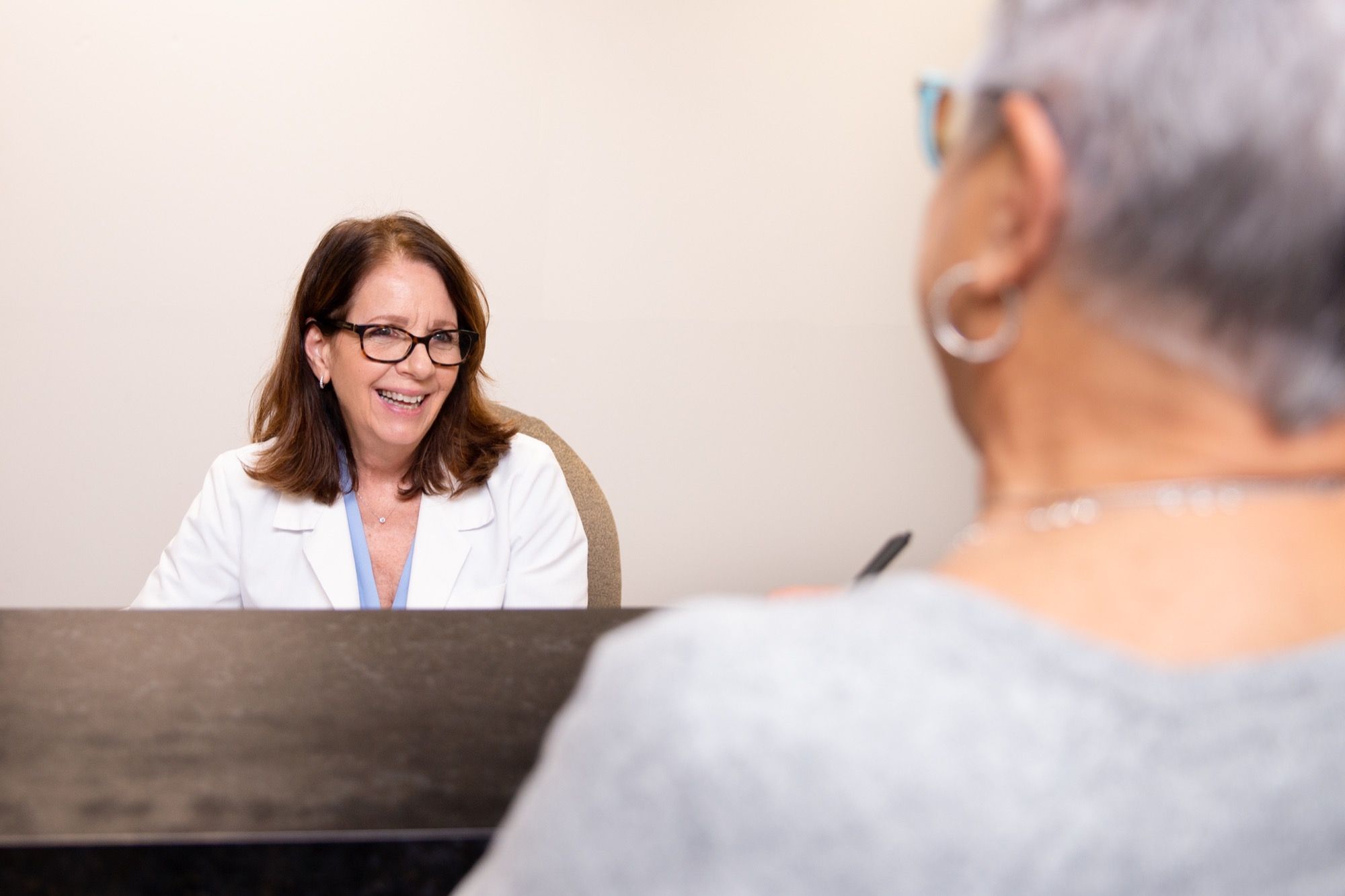 An optometrist talking with a patient