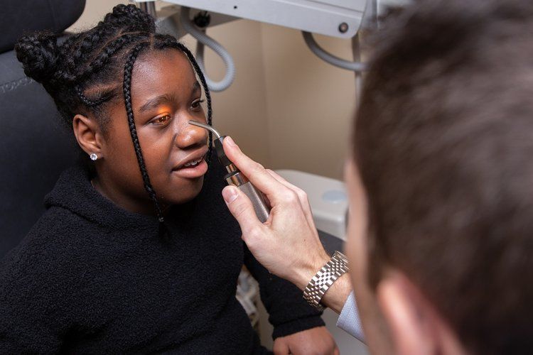 An optometrist examining a child's eyes