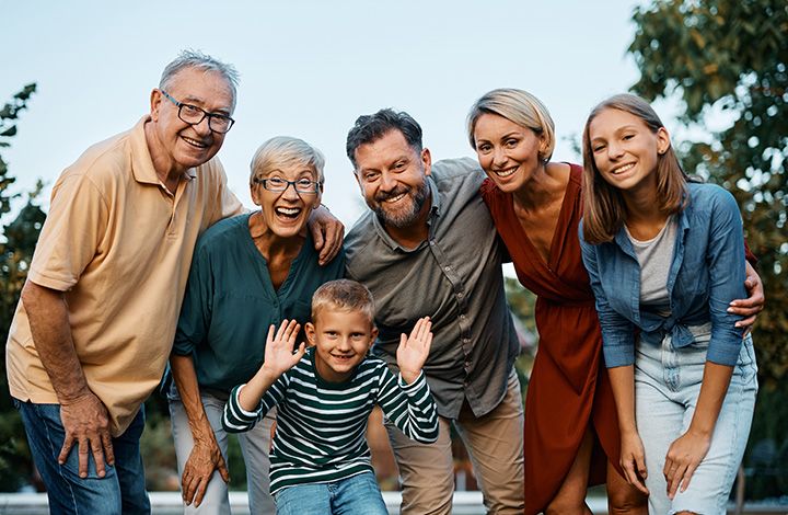 A smiling multigenerational family outdoors